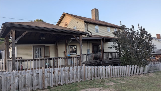 rear view of house featuring covered porch