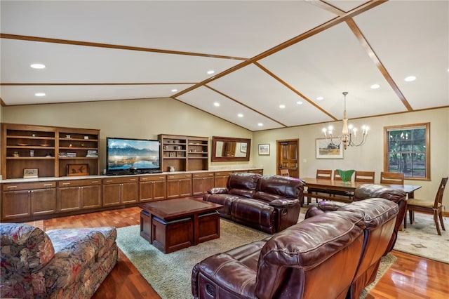 living room featuring a notable chandelier, wood-type flooring, and vaulted ceiling