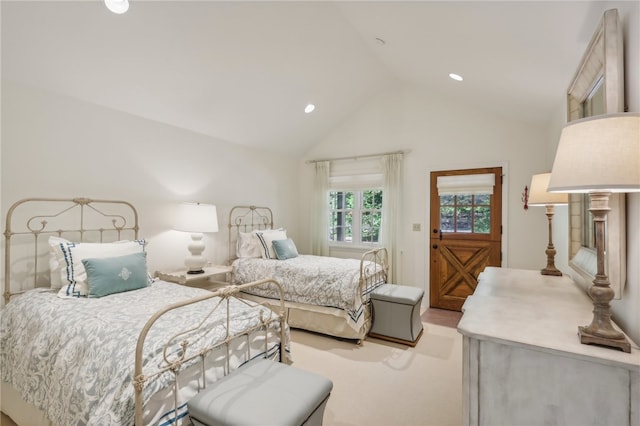 carpeted bedroom with high vaulted ceiling