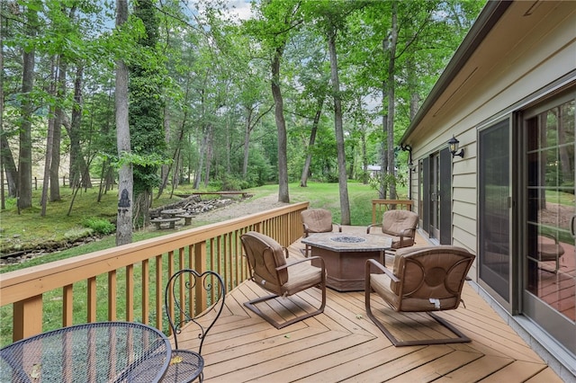 wooden terrace with an outdoor fire pit