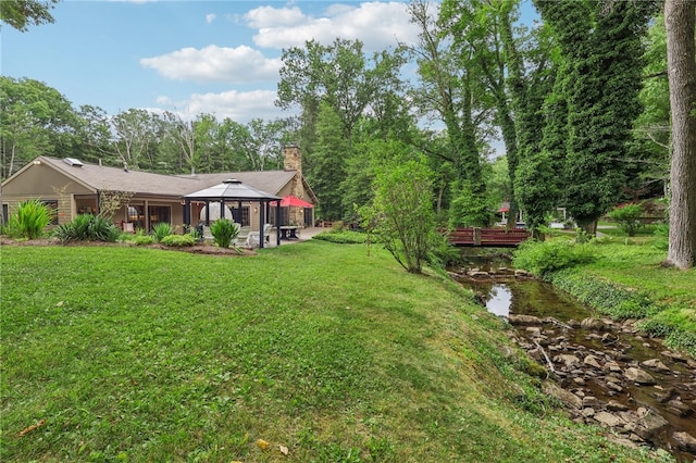 view of yard with a water view and a gazebo