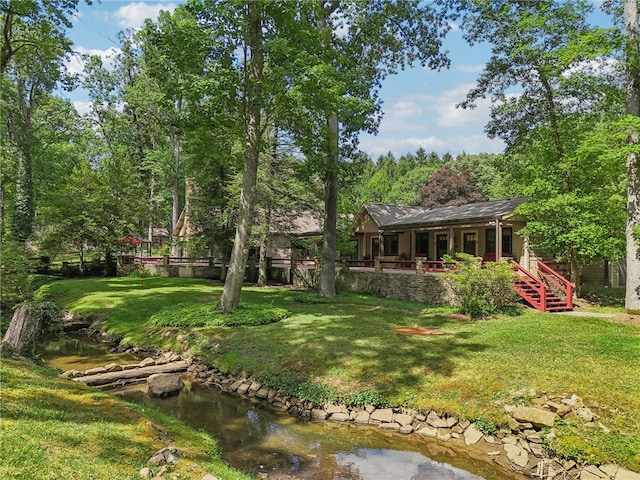 rear view of property featuring a yard