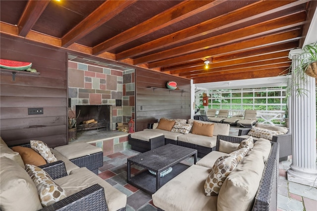 tiled living room featuring beamed ceiling and wooden walls