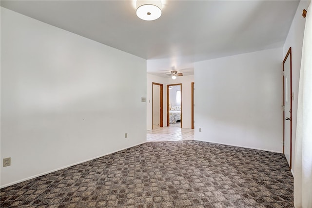 spare room featuring ceiling fan and carpet flooring