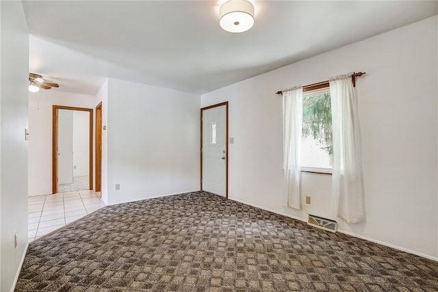 carpeted entrance foyer featuring ceiling fan