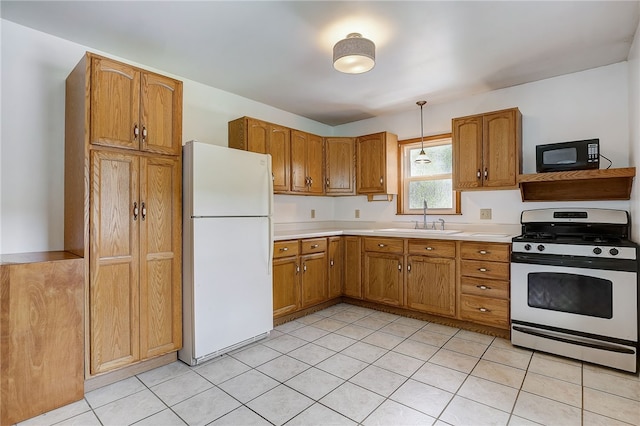 kitchen featuring sink, hanging light fixtures, white appliances, and light tile patterned floors