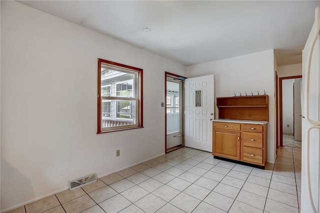 unfurnished bedroom with light tile patterned flooring