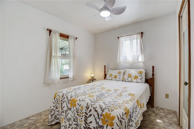 carpeted bedroom with multiple windows, a closet, and ceiling fan