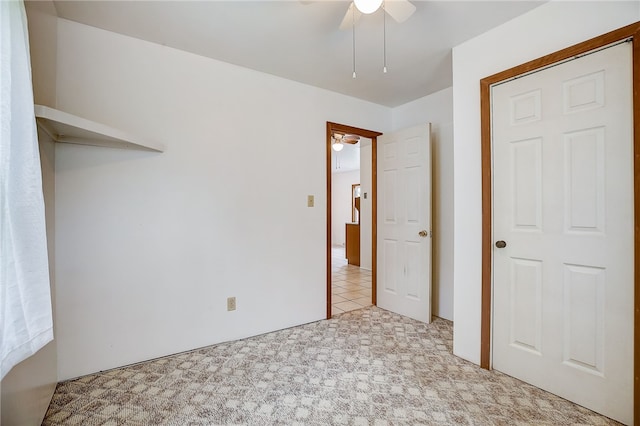 unfurnished bedroom featuring ceiling fan and light tile patterned floors