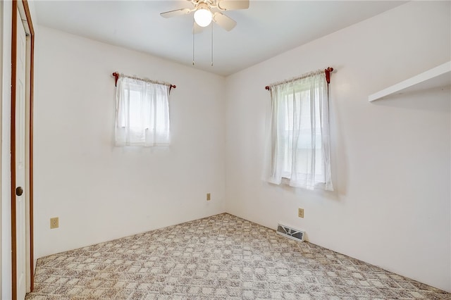 unfurnished room with carpet and ceiling fan