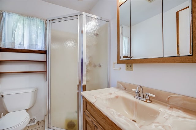 bathroom featuring tile patterned flooring, walk in shower, toilet, and vanity