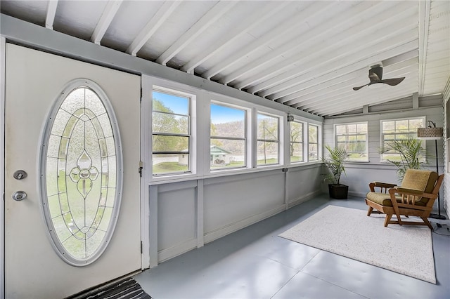 sunroom / solarium featuring vaulted ceiling with beams and ceiling fan