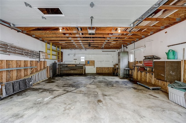 garage with a garage door opener and a workshop area