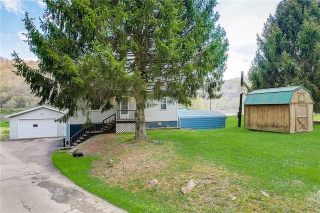 view of front facade featuring a garage, a front lawn, and a storage unit