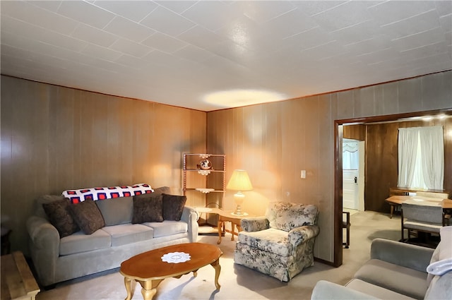 living room featuring carpet flooring and wooden walls