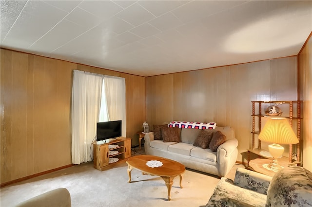 carpeted living room featuring wood walls