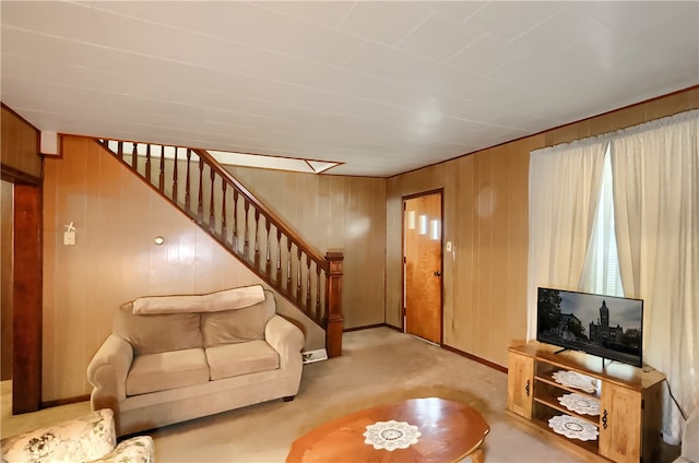 living room featuring carpet floors and wooden walls