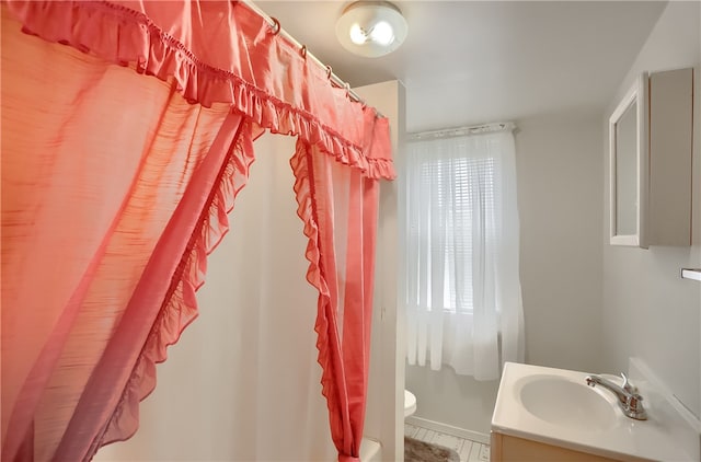 bathroom with vanity, toilet, and tile patterned flooring