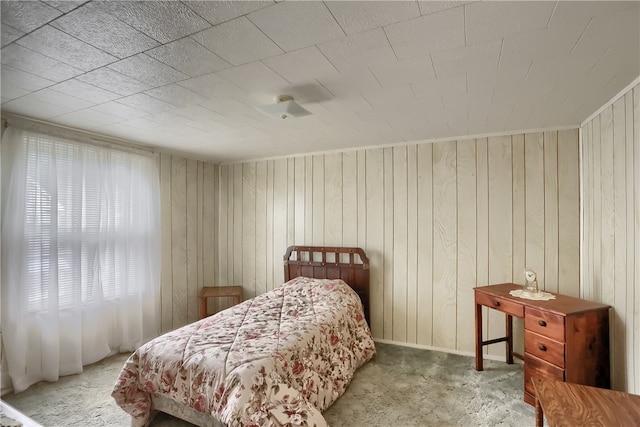 carpeted bedroom with wooden walls