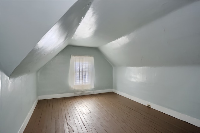 bonus room with lofted ceiling and wood-type flooring