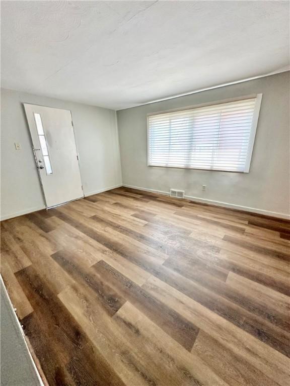 spare room featuring wood-type flooring