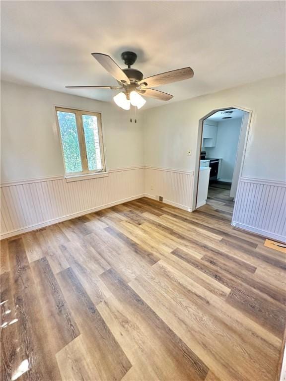 spare room featuring ceiling fan and light hardwood / wood-style floors