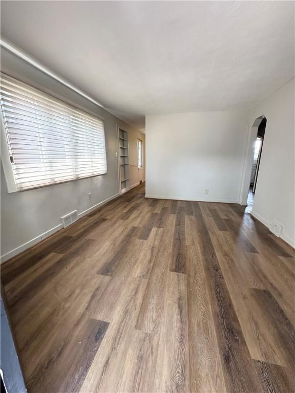 empty room with dark hardwood / wood-style flooring