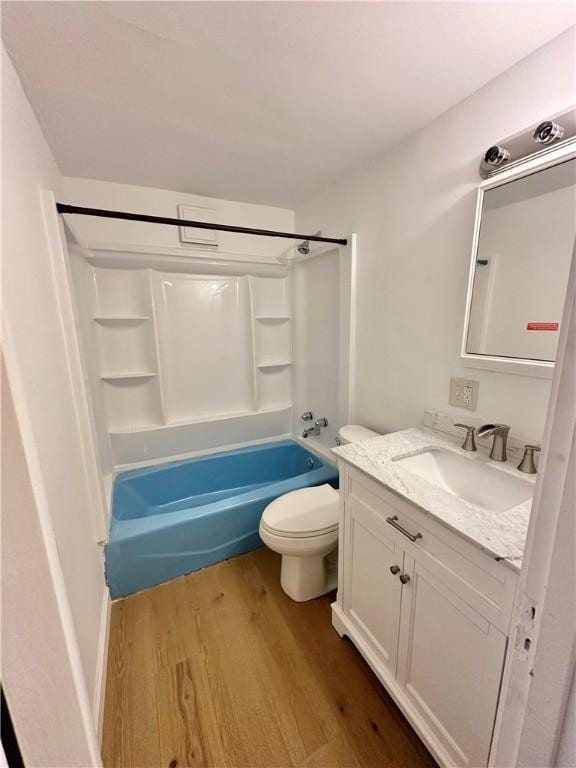 full bathroom with wood-type flooring, shower / tub combination, vanity, and toilet