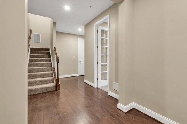 corridor with dark wood-type flooring