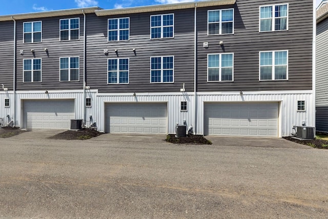 view of front of home featuring cooling unit and a garage