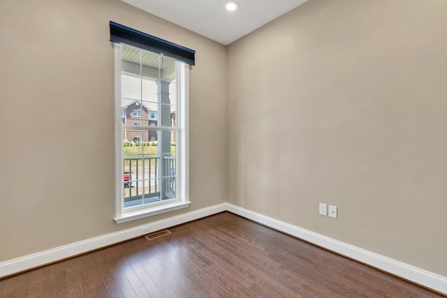 spare room featuring dark wood-type flooring