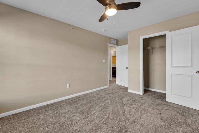 unfurnished bedroom with a closet, carpet flooring, and ceiling fan