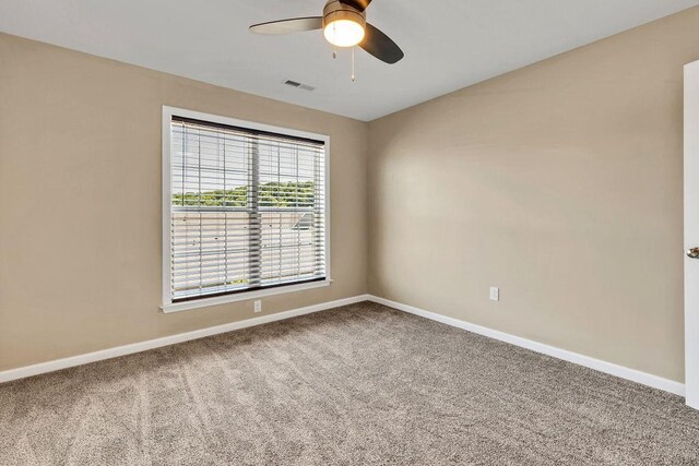 empty room with carpet flooring and ceiling fan