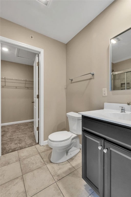 bathroom featuring vanity, toilet, and tile patterned flooring