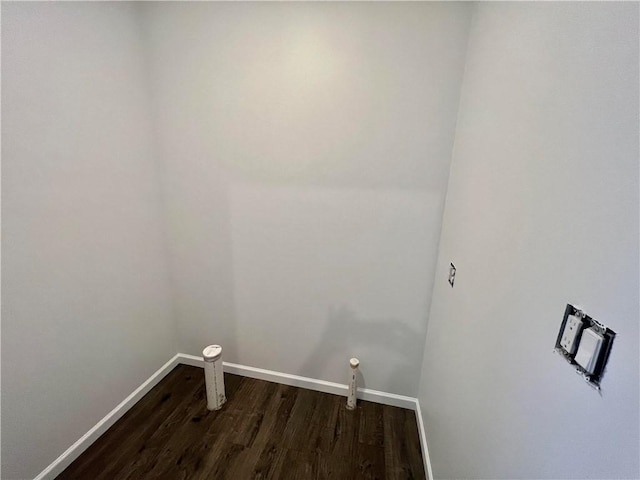 clothes washing area featuring dark hardwood / wood-style flooring