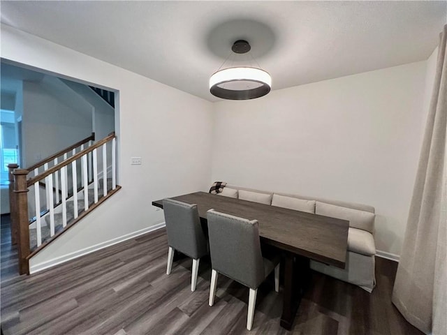 dining area featuring dark wood-type flooring