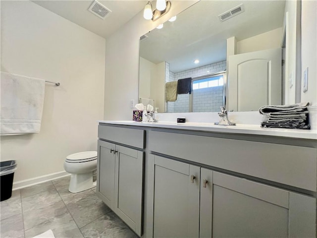 bathroom with vanity, toilet, and a shower with shower door