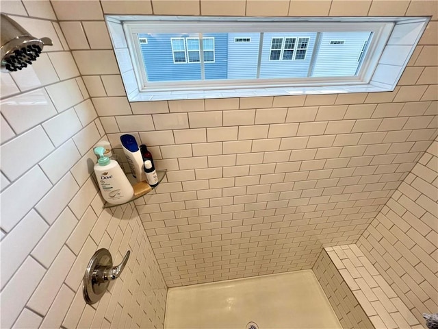 bathroom with a tile shower