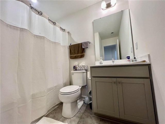 bathroom featuring vanity, toilet, and curtained shower