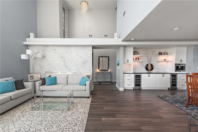 living room featuring beverage cooler and dark hardwood / wood-style flooring