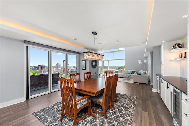 dining space with dark hardwood / wood-style floors and beverage cooler