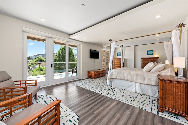 bedroom with access to exterior and hardwood / wood-style floors