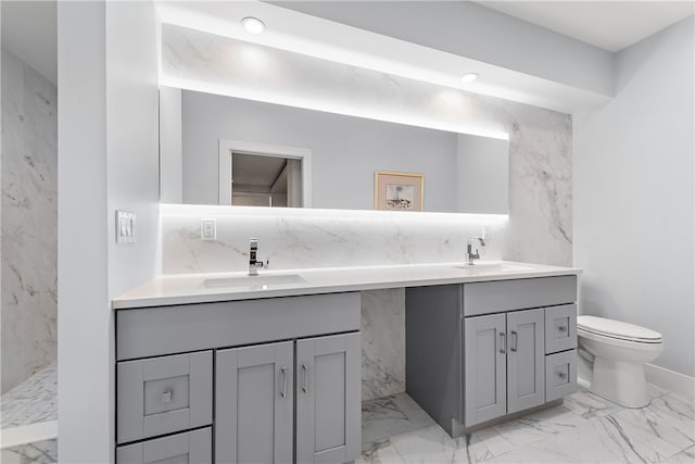 bathroom featuring double vanity, tile patterned floors, and toilet