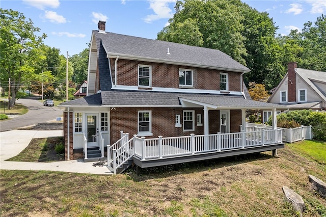 rear view of house featuring a yard