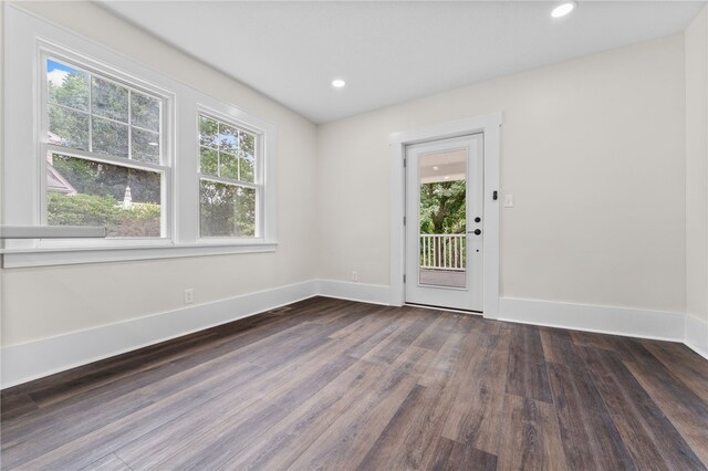 interior space featuring plenty of natural light and dark hardwood / wood-style floors