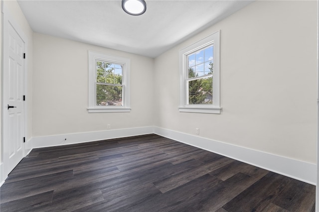 unfurnished room with dark hardwood / wood-style floors