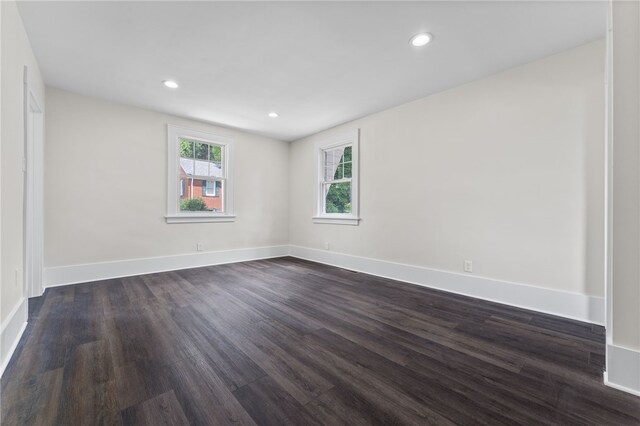 unfurnished room with dark hardwood / wood-style floors