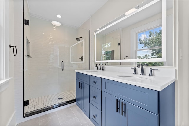 bathroom featuring double vanity, tile patterned floors, and a shower with door