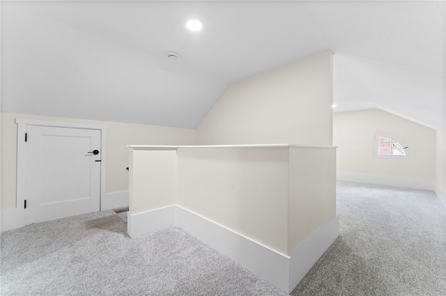 bonus room with carpet flooring and lofted ceiling