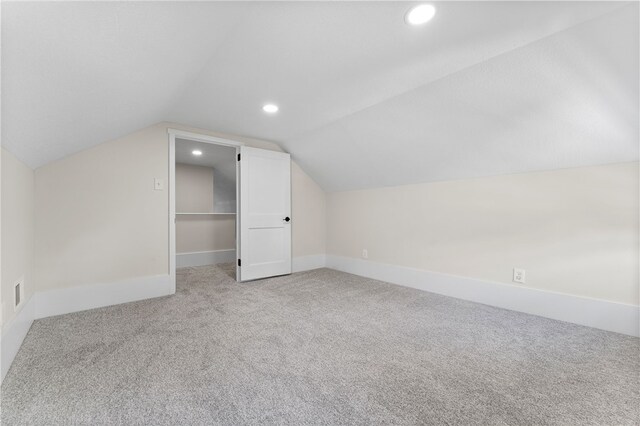 bonus room featuring lofted ceiling and carpet